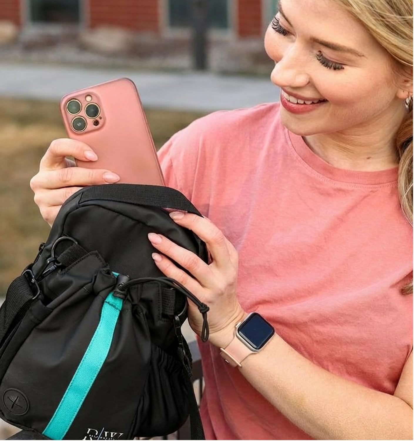 A woman using the detachable Red’s Way crossbody with its blue stripe